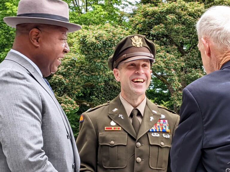 An army colonel greets visitors